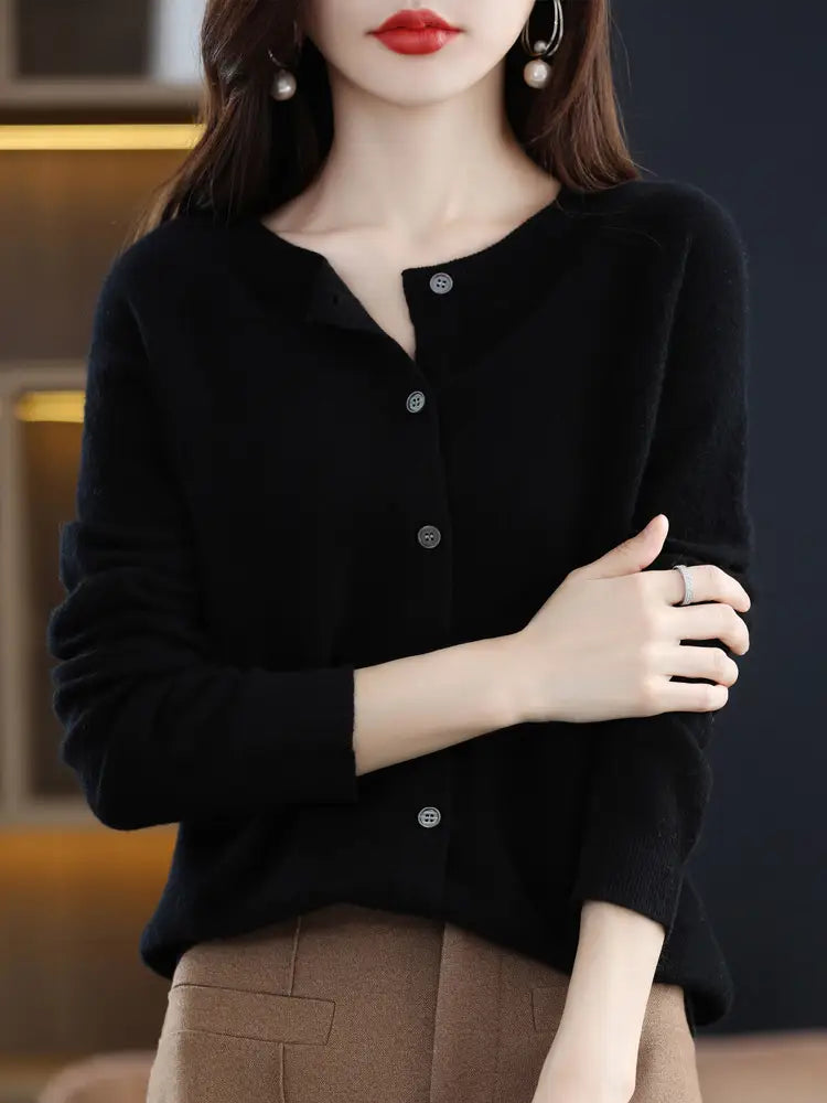 Black long-sleeved merino wool cardigan for women with subtle textured knit and silver-toned buttons.