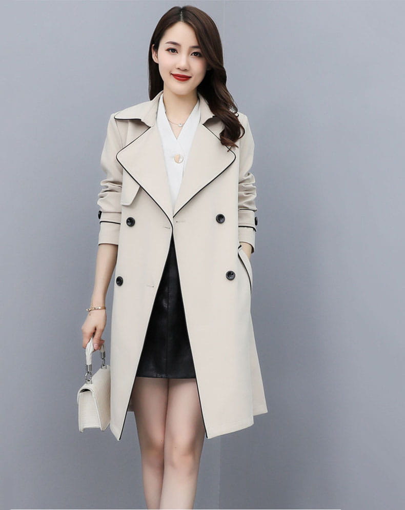 Beige women double breasted trench coat with black trim and buttons made from durable fabric.