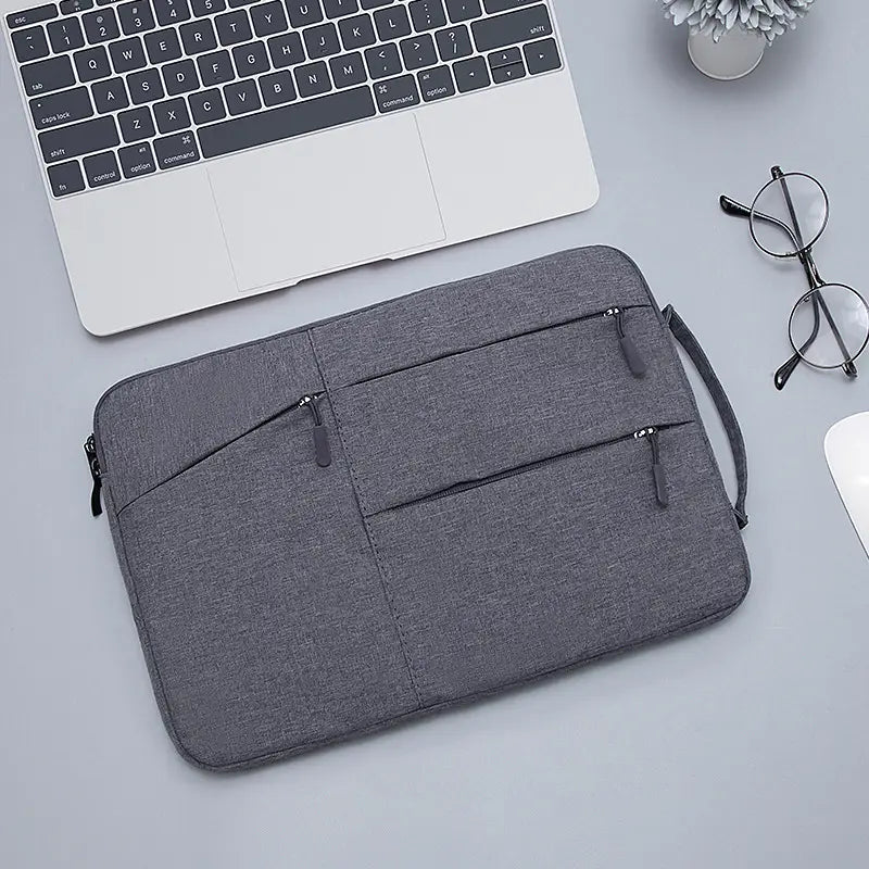 Gray textured laptop sleeve bag for Macbook Air and Pro with multiple zippered compartments and a carrying handle designed as a protective laptop sleeve.