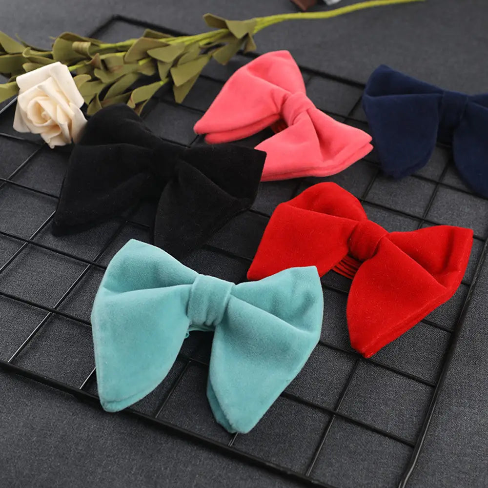A collection of velvet bow ties in black coral pink navy blue red and teal suitable for formal neckwear gifts.