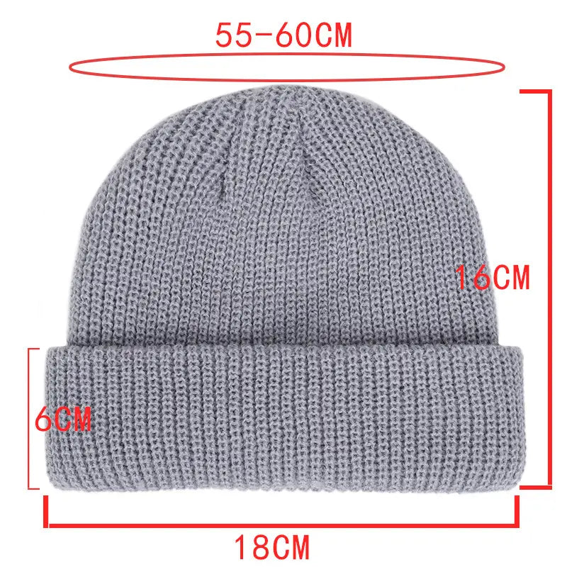 A gray ribbed knit winter beanie hat featuring a folded brim made from warm knitted material for unisex use.