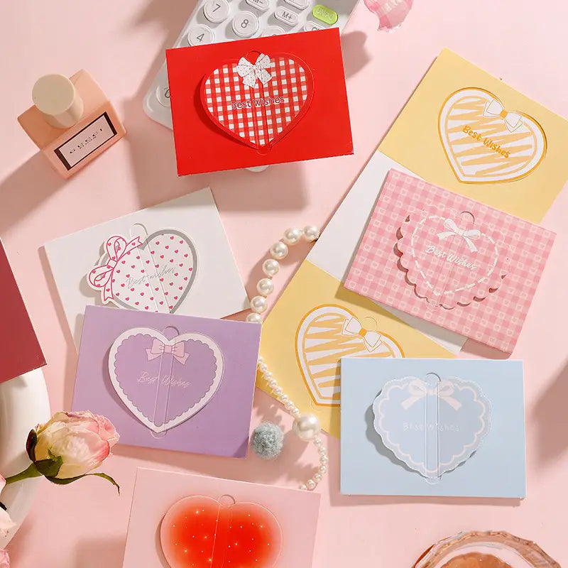 Pastel-colored 3d heart greeting cards set featuring heart-shaped notecards with decorative bows, best wishes text, and various patterns including gingham, polka dots, and stripes for valentine and wedding notes.