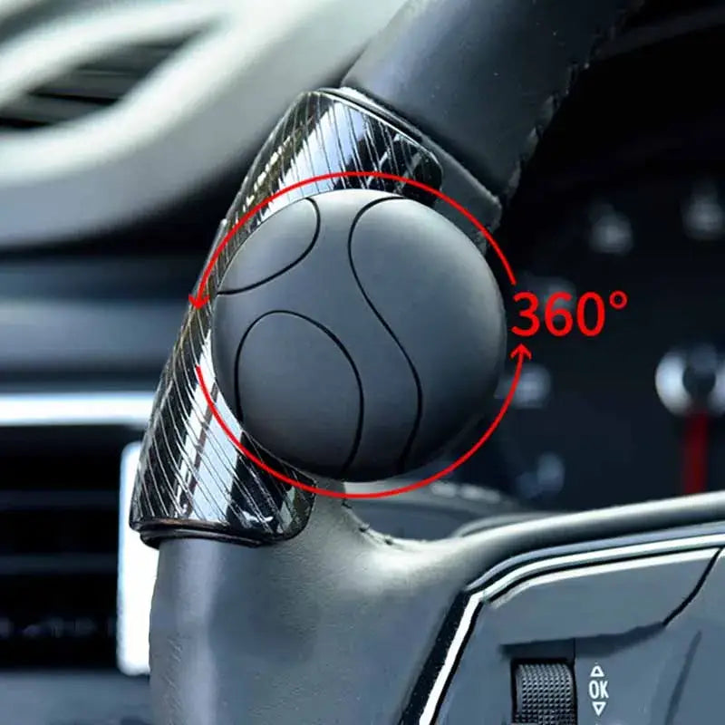 Black steering wheel spinner knob with 360 degree rotation and carbon fiber textured base for turn assist.