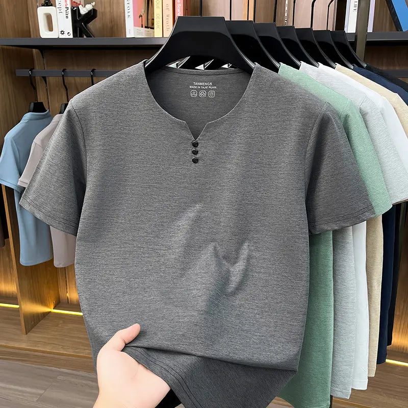 Camisa tipo henley jaspeada para hombre de manga corta color gris con tapeta de botones negros, diseñada como camiseta informal tipo henley con textura.