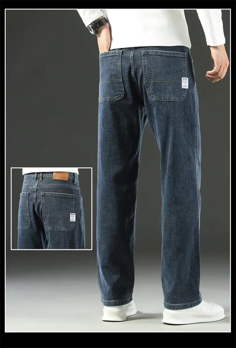 men’s loose straight business casual dark blue denim jeans with a relaxed fit and subtle fading showing the back side with classic pockets and a small white label on the right pocket.