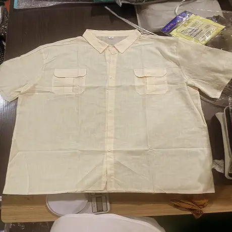 A beige men linen short sleeve shirt with double chest pockets and a classic collar suited for casual summer wear.
