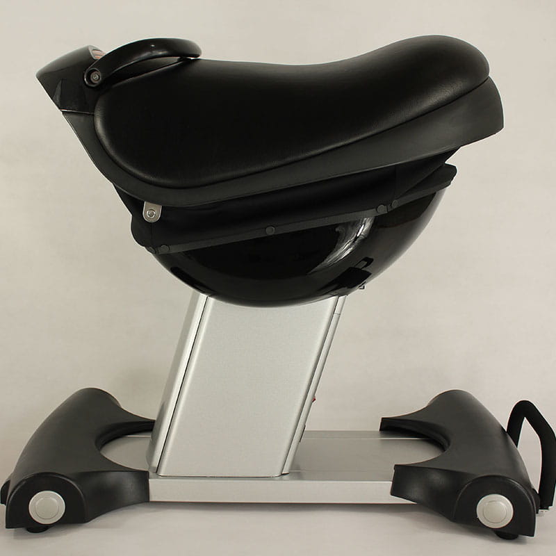 Black leather saddle-style horse riding exercise machine fitness equipment with a silver metallic base and black plastic footrests.