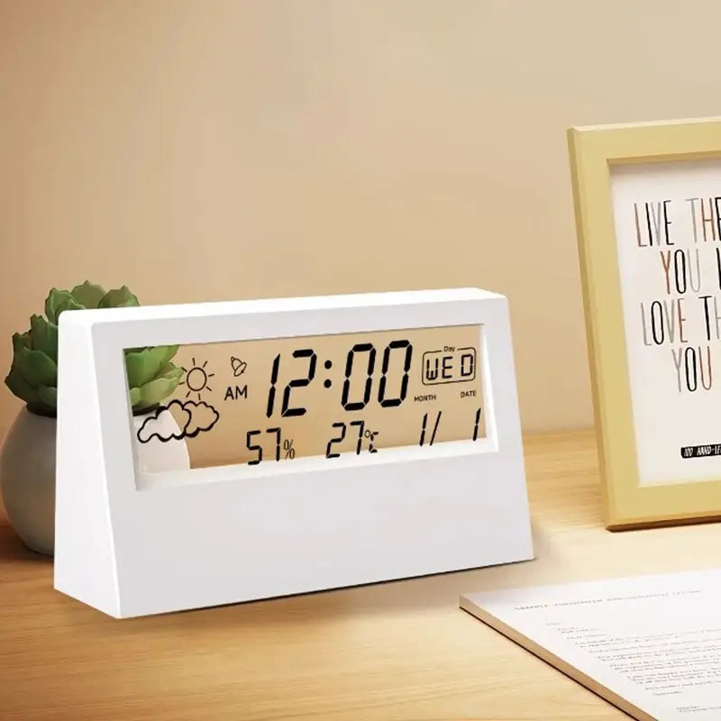 white rectangular digital weather desktop alarm clock displaying time day date temperature humidity and cartoon weather icons on screen