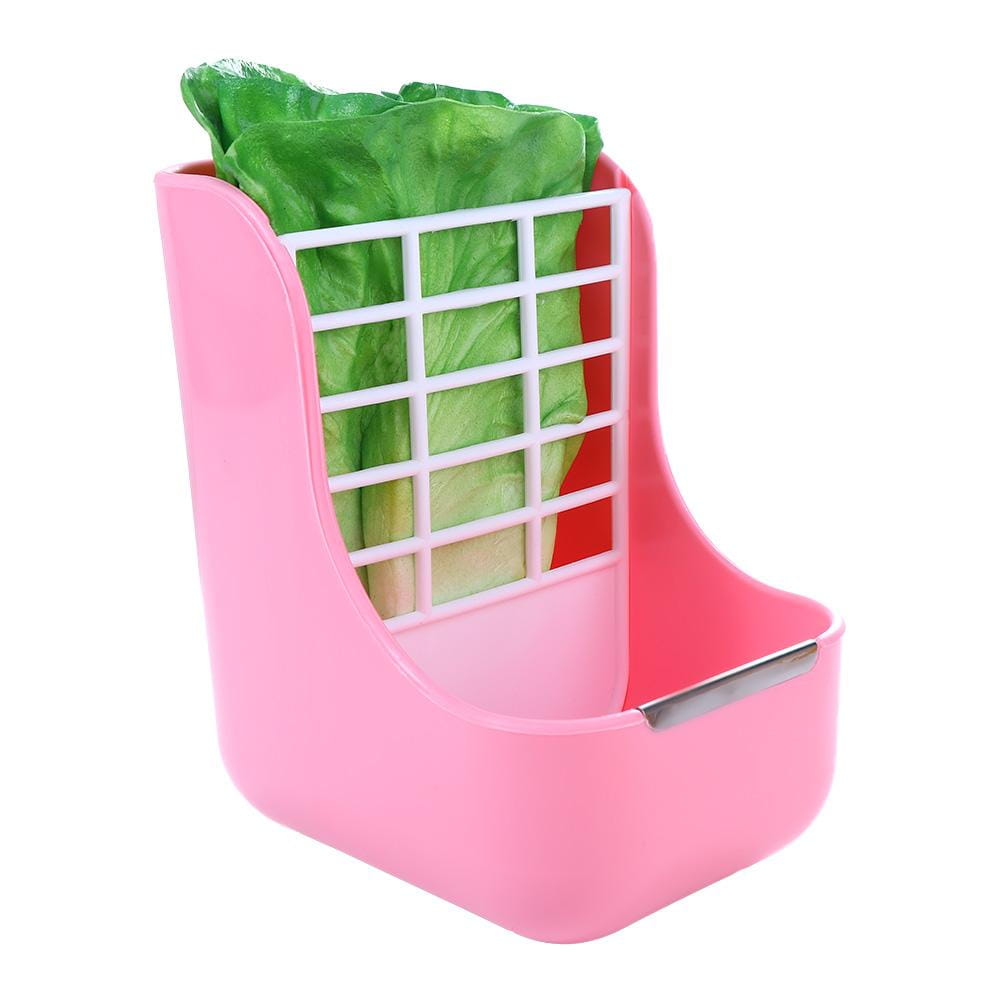 Pink plastic rabbit hay feeder with white grid insert containing green lettuce designed for small animals as a hay feeder and food bowl.