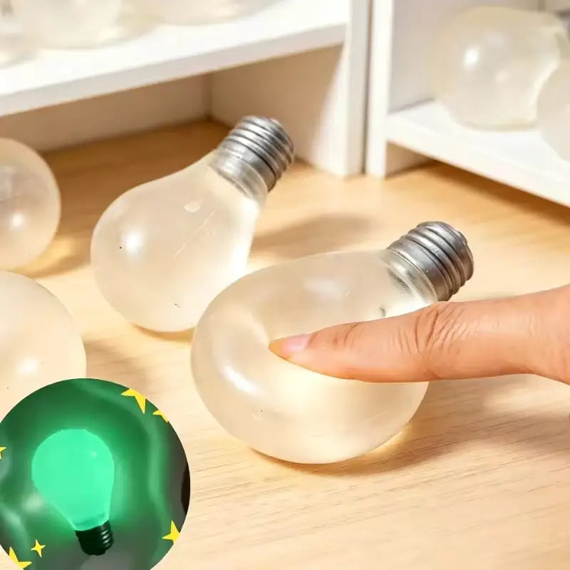 translucent silicone stress ball shaped like a light bulb with a metallic screw base designed as a sensory stress reliever squeeze toy.