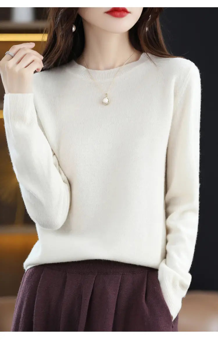 Cream-colored long-sleeved pure wool cashmere o-neck pullover sweater with a soft knit texture and round neckline.
