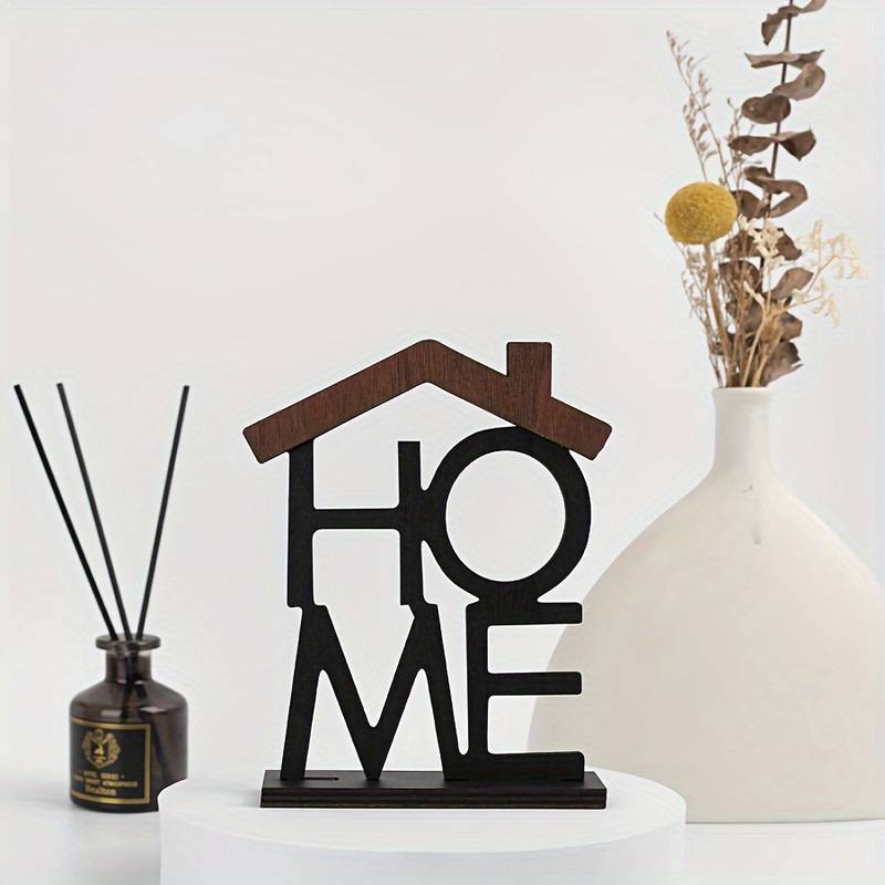 Dark wood and black laser-cut wooden home sign shaped like a house used as shelf decor.