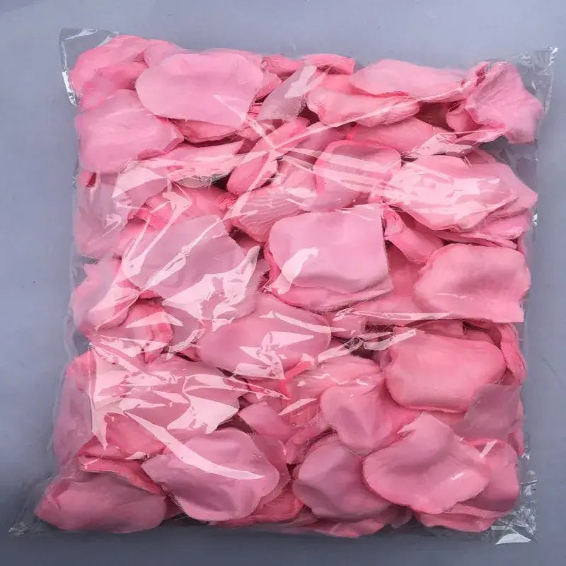 A clear plastic bag filled with soft pink artificial rose petals for colorful rose petals wedding decor.