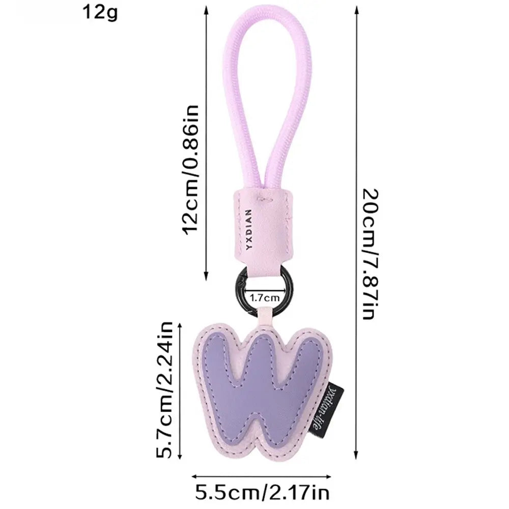 A soft lavender leather initial keychain letter wristband charm with a stitched w design, matching loop, and black metal ring.