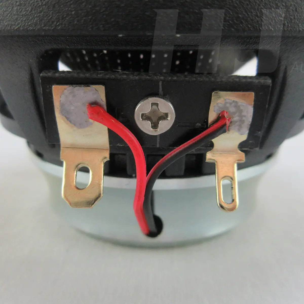 The back side of a black 3.5 inch car coaxial speaker with red and black wires connected to gold-colored terminal lugs rated 200w qp353f.