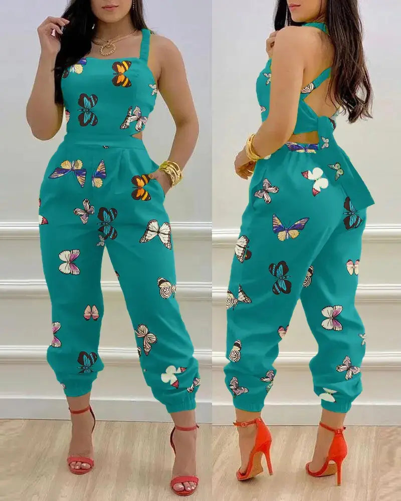 Teal butterfly-print women summer printed cutout jumpsuit with halter neck and side cutouts designed for warm weather wear.