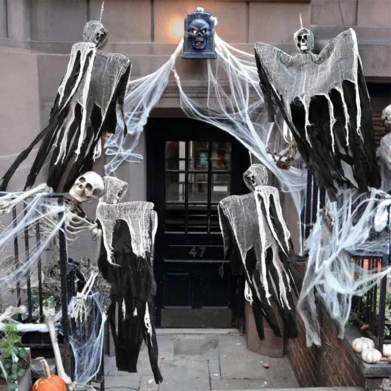 hanging ghost halloween decoration featuring black and white ghostly figures with tattered fabric robes hanging from a doorway ideal for creating spooky atmosphere in remote area settings.