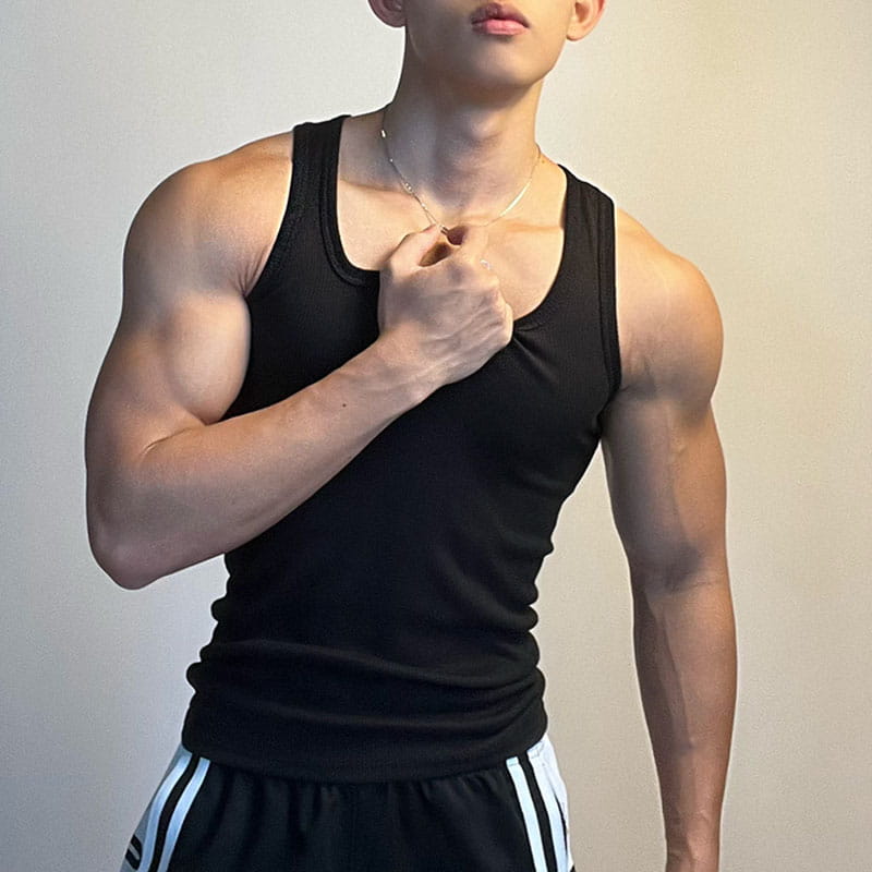 Black sleeveless tank top with a simple fitted design from men solid color casual tank top collection available in sizes S to 5XL.