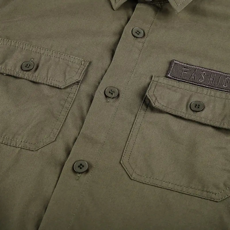 Men cotton casual long sleeve military cargo shirt in olive green featuring two chest pockets with dark gray buttons and an embroidered fashion patch on the right pocket.