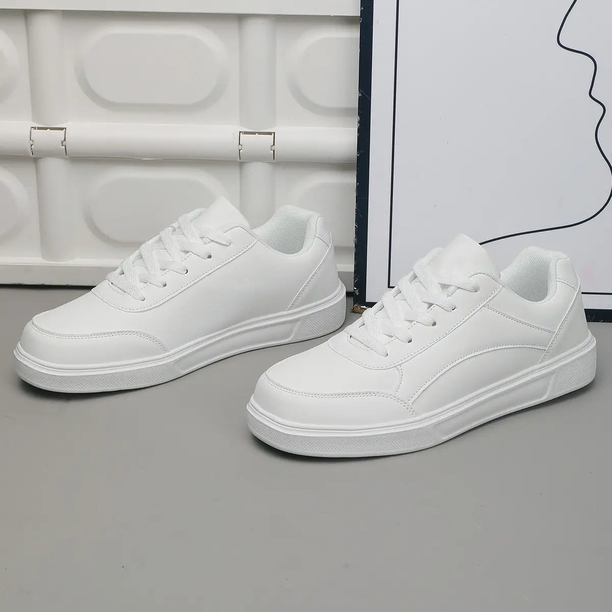 Men white leather minimalist low top sneakers with clean design and matching laces.