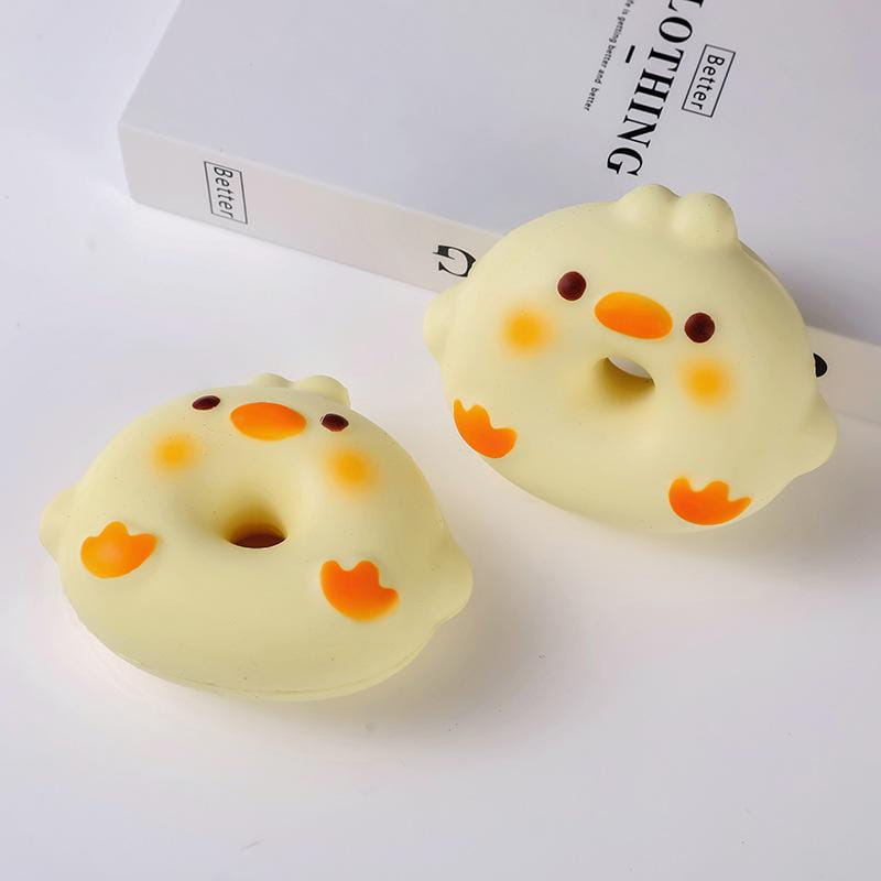 Cute yellow chick-shaped slow rising toast fidget toys with orange beaks and feet designed for stress relief and daily stress reduction as a fun desktop decoration.