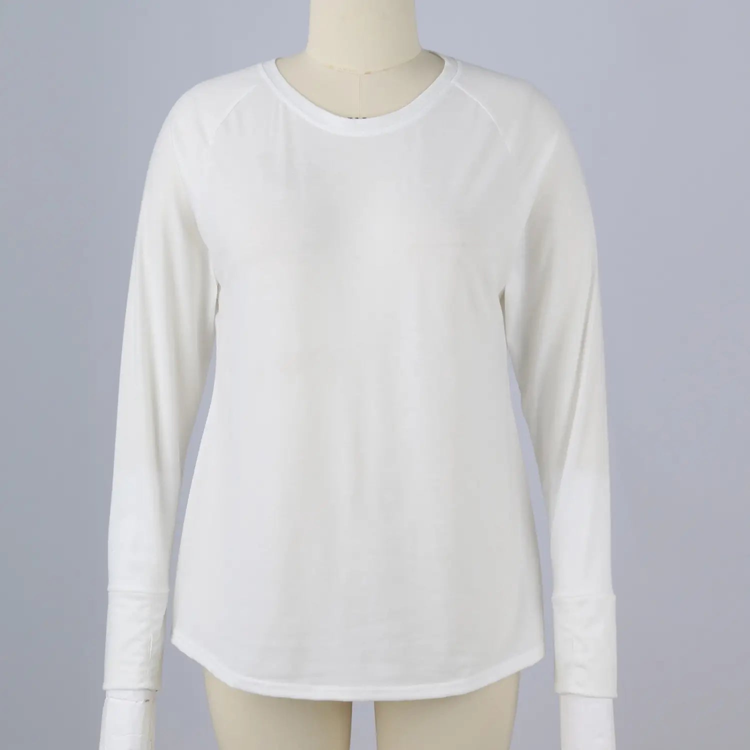 white long sleeve cotton tunic top featuring a round neck and subtle raglan sleeve length with a plain pattern type.