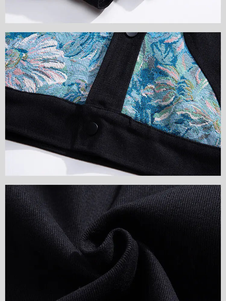 Schwarze Cord-Bomberjacke im Streetwear-Stil mit floraler Stickerei; mit lebhaftem blauem floralen Stickerei-Paneel und schwarzen Knöpfen.