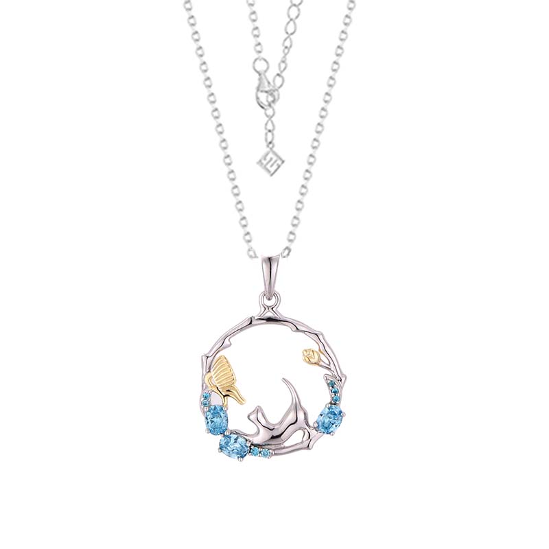 925 silver cat zirconia jewelry set featuring a silver and gold pendant necklace with a circular design, blue gemstones, an intricate bird motif, and a delicate chain.