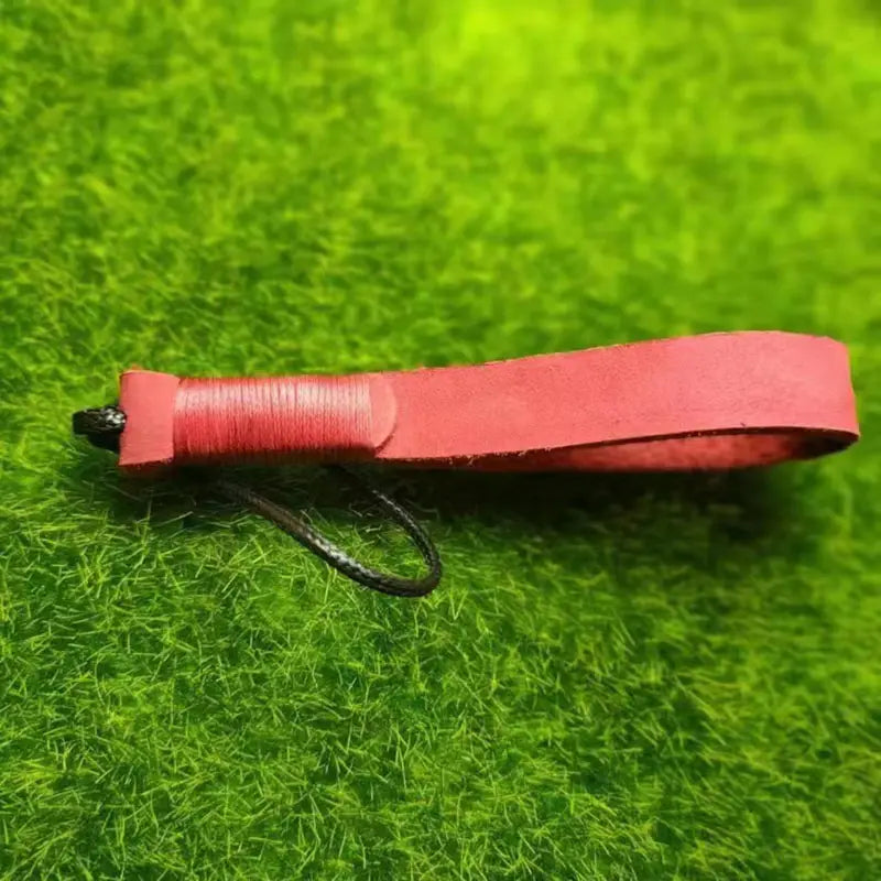 Red leather weave lanyard keychain car key holder with a black cord and wrapped handle.