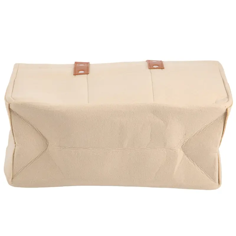 Beige canvas felt baby diaper caddy with two brown leather straps for nursery storage.