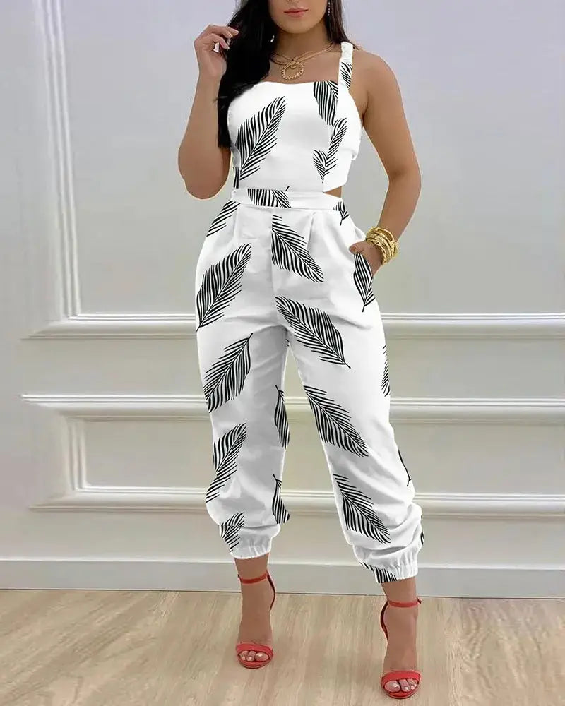 Women summer printed cutout jumpsuit featuring a white fabric with black palm leaf print, designed as a crop top paired with wide-leg pants.