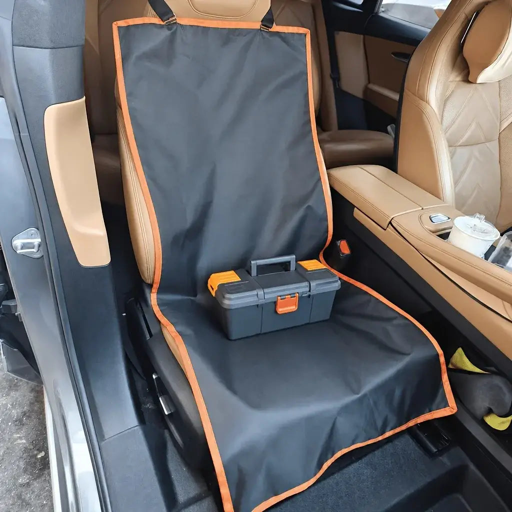 Black waterproof dog car seat cover with orange trim and reinforced stitching designed to protect the vehicle interior.