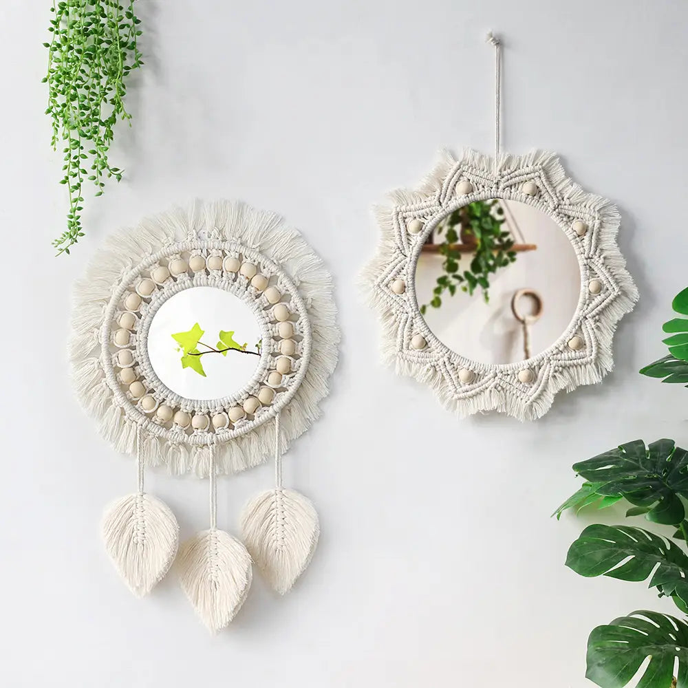 Two cream-colored boho macrame wall mirrors with beaded borders, fringed edges, and hanging leaf-shaped tassels, ideal for living room home decor.