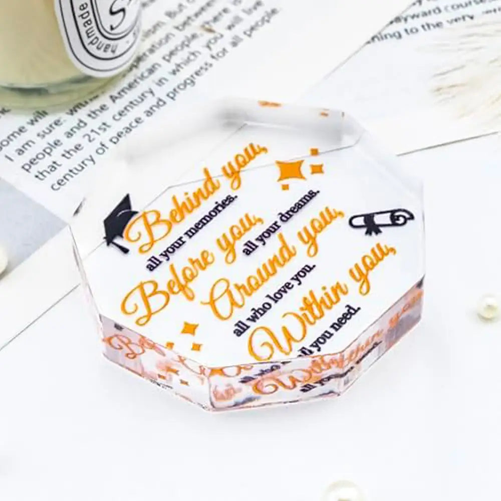 Clear hexagonal acrylic keepsake box with orange and black printed graduation-themed message designed as a desktop decor graduation gift.