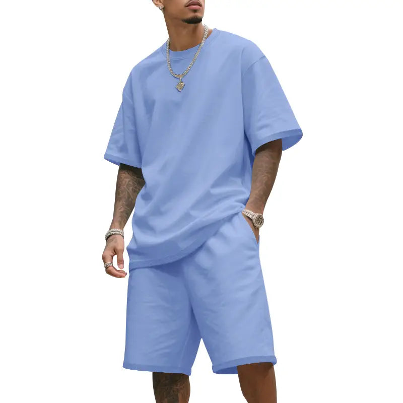 Camiseta de algodón oversize azul claro con mangas cortas y ajuste relajado, de la ropa de verano casual para hombre de dos piezas, camiseta y conjunto de pantalones cortos.