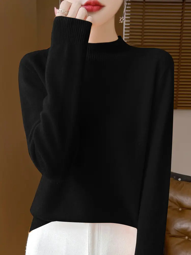 Black ribbed-knit merino wool pullover sweater for women with long sleeves and a high neckline.