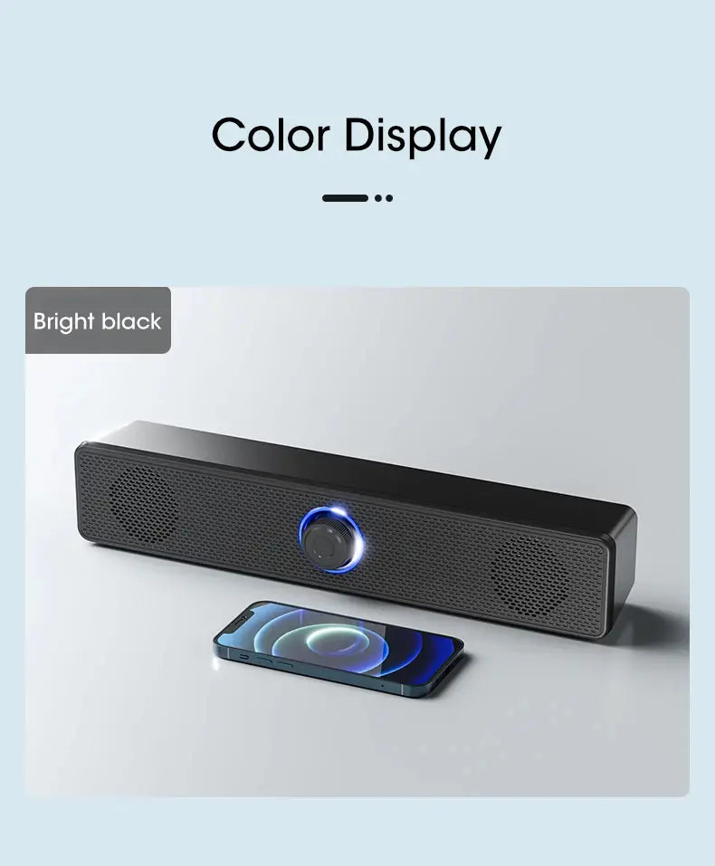 Barre de son pour PC rectangulaire noire brillante, avec centre circulaire lumineux bleu et grilles de haut-parleurs perforées, conçue comme un haut-parleur de bureau sans fil Bluetooth USB.