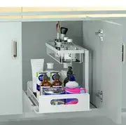 Organisateur d’évier en forme de L à deux niveaux en plastique blanc, avec compartiments de rangement transparents et une poignée avant, pour une utilisation dans les placards de cuisine et de salle de bains