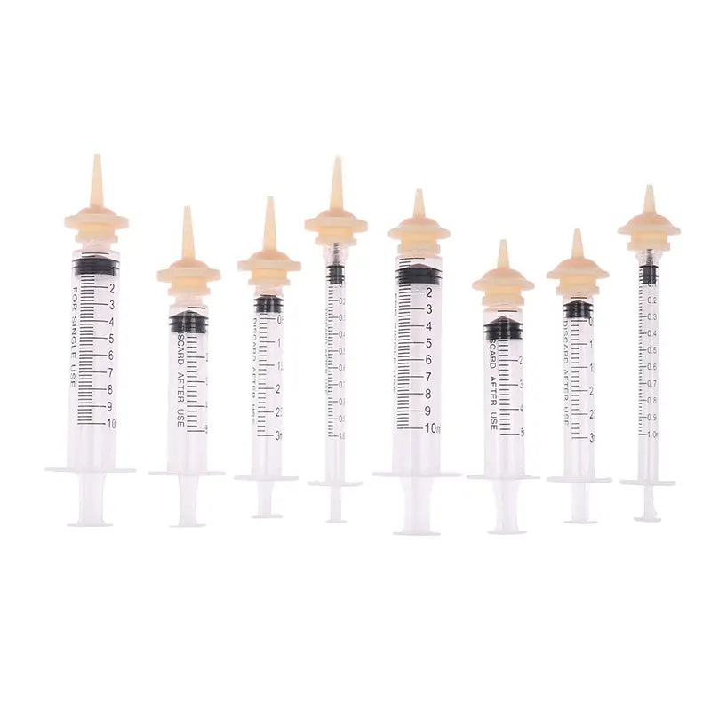 set of clear plastic pet oral syringes with beige caps and black measurement markings in 1ml 3ml and 5ml sizes labeled island after use for feeding with silicone nipple feeder