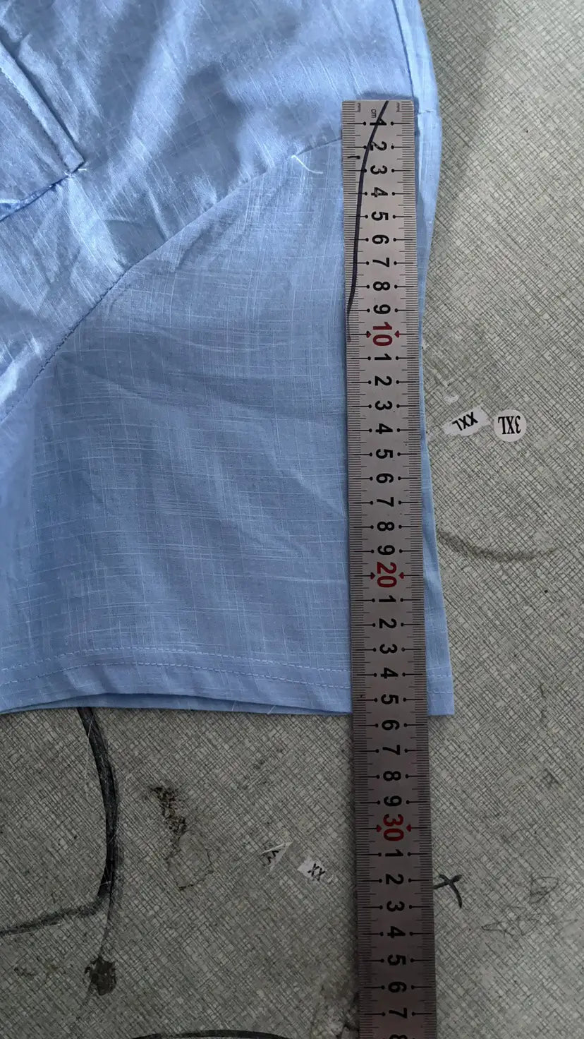 Light blue men linen short sleeve shirt with a subtle grid pattern double pocket design and soft fabric texture for casual summer wear.