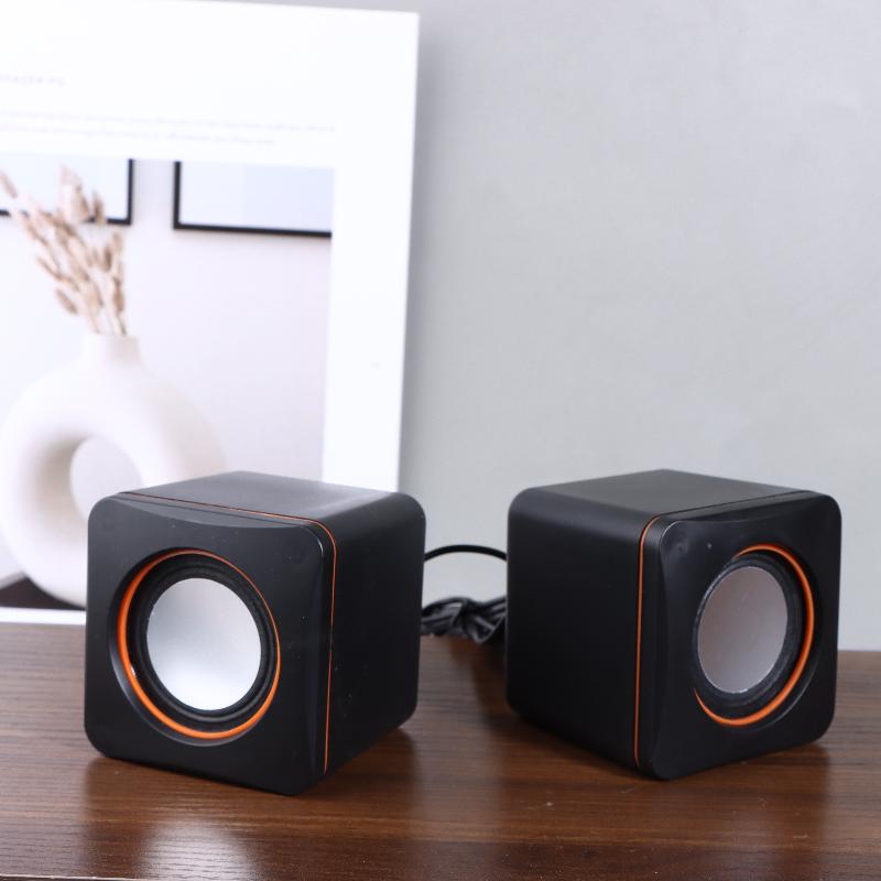 Black cube-shaped usb computer speakers with orange trim and led stereo desktop pc audio features