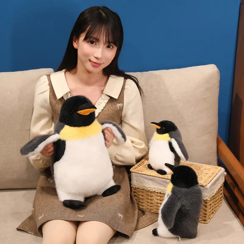 Plush penguin stuffed animal soft toy pair featuring a black head, white belly, and yellow chest band made of soft material.