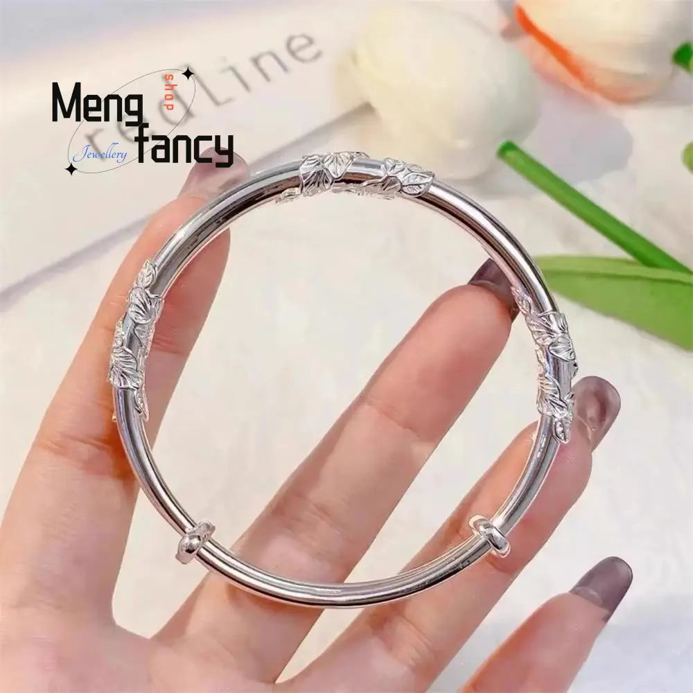 Silver leaf-patterned floral sliding bangle bracelet with a sleek polished finish and adjustable clasp featuring natural jade raw stone and raw stone accents.