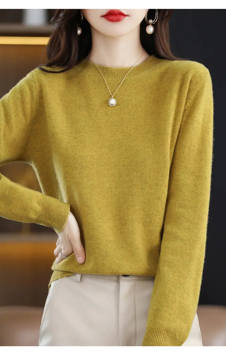A soft olive green pure wool cashmere o-neck pullover sweater with a round neckline and ribbed cuffs.