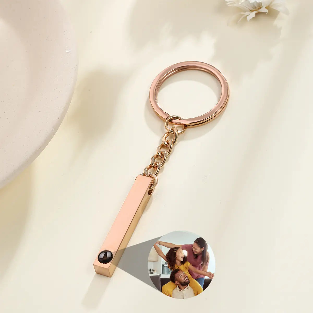 Rose gold rectangular custom photo projection keychain with a circular inset image of three people personalized as a memorial gift.