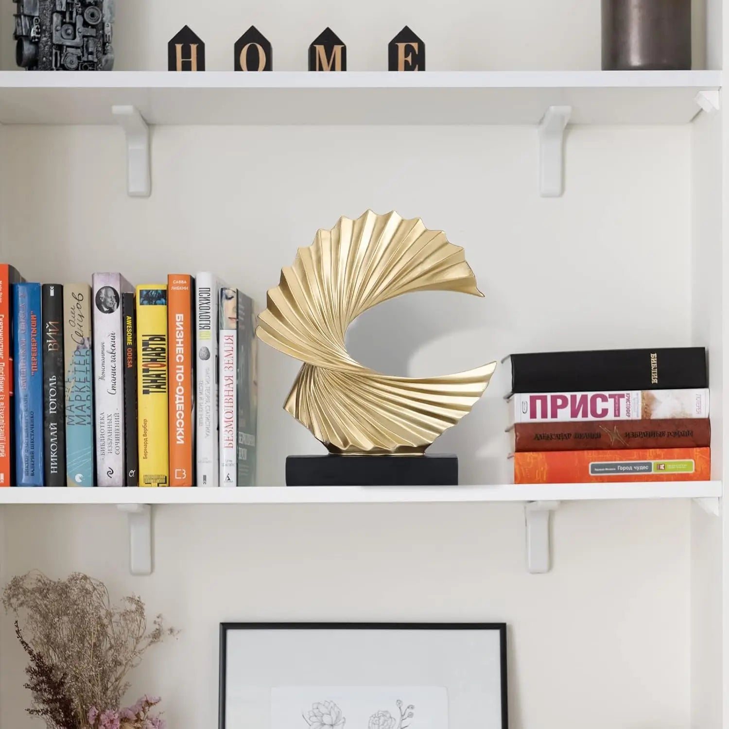 golden metallic art deco fan-shaped sculpture with black base for tabletop decor
