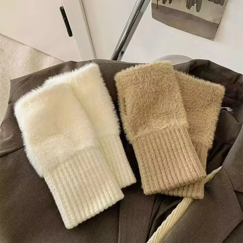 Fluffy fingerless knit gloves in cream and beige feature a fuzzy texture with ribbed knit cuffs for warmth and style.