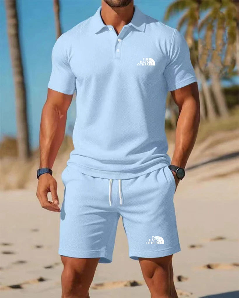 Light blue north face men’s knit polo shirt with white logo on the chest in a polo and shorts set.