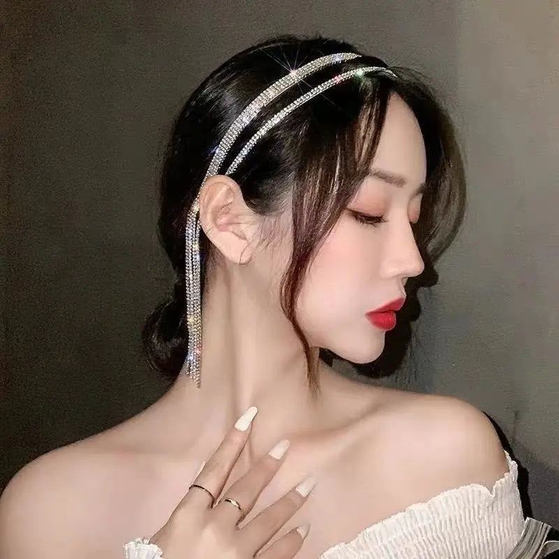 A sparkling silver crystal rhinestone tassel headband for women featuring dangling crystal chains.