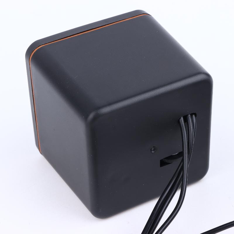 Black cube-shaped usb computer speaker with matte finish and subtle copper-colored trim for led stereo desktop pc audio.